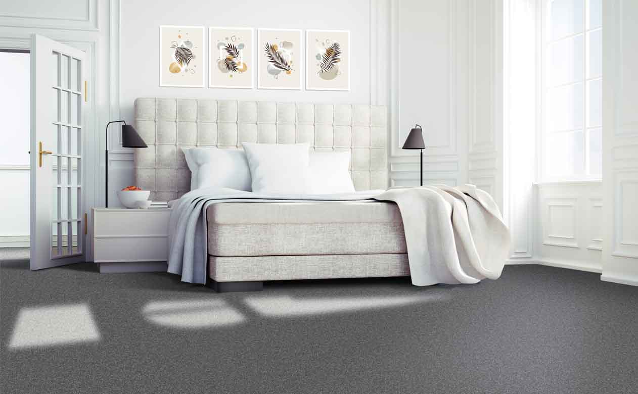 Bedroom with bed and window, grey carpet floor
