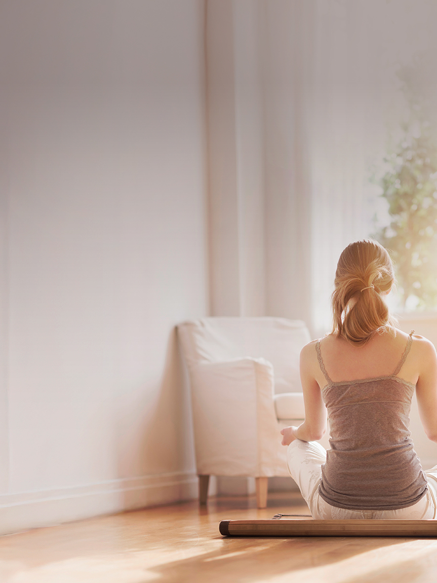 Woman doing Yoga on Hardwood Floor