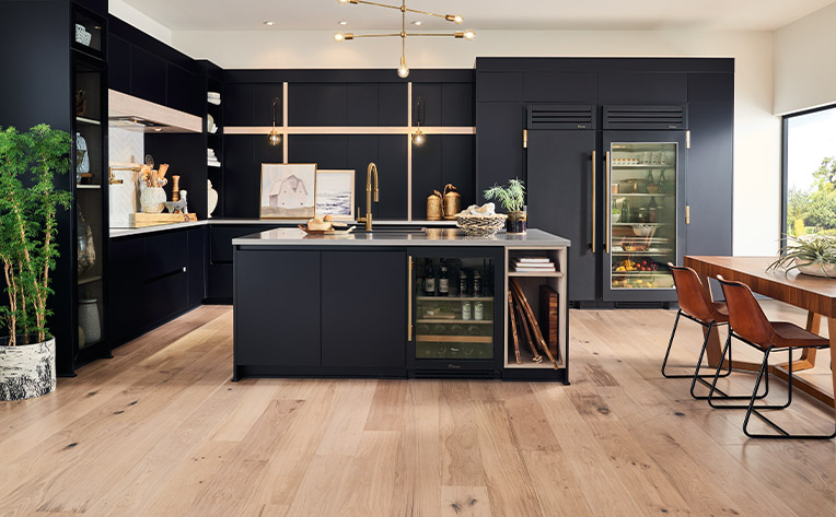 hardwood flooring in modern kitchen with blue cabinetry